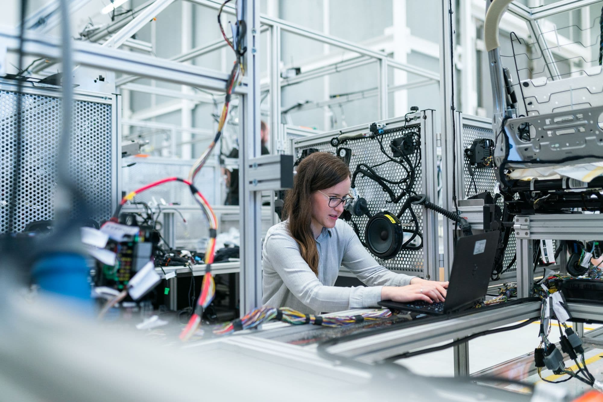 An engineer working with production information at an assembly station