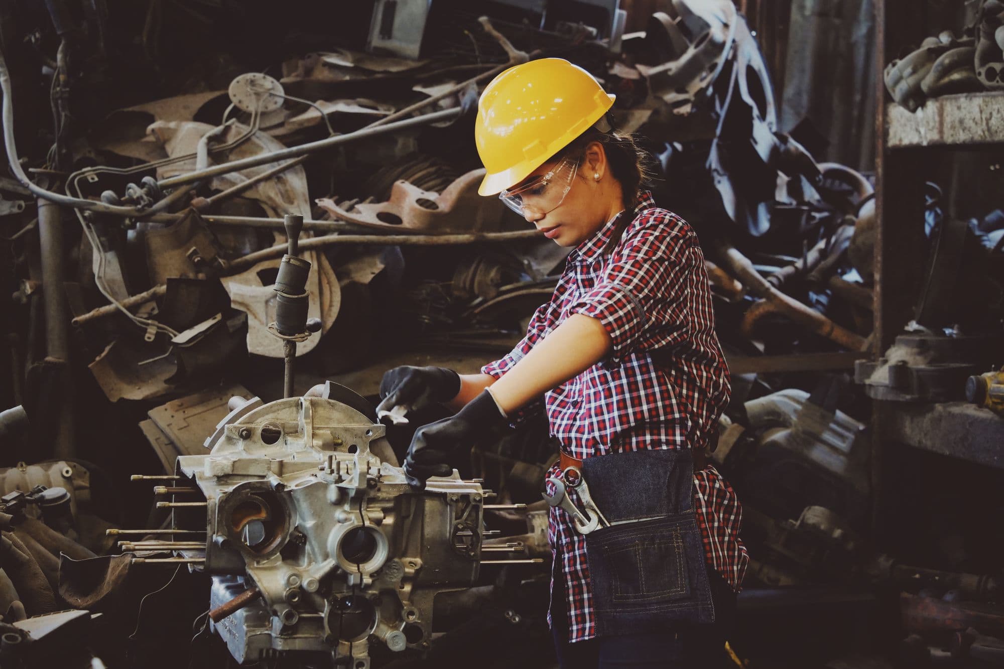 A manufacturing technician inspecting equipment on the shop floor